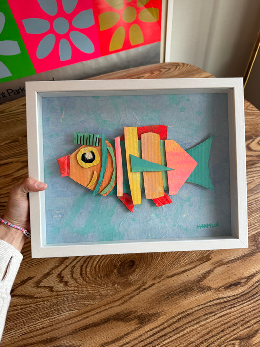 “Amazon Box Fish (Saving the Word, Obviously)” – Recycled Collage Fish | 11x14 Framed